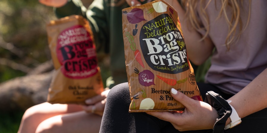 Naturally Delicious Brown Bag Veggie Crisp packet with Vegan Trademark displayed