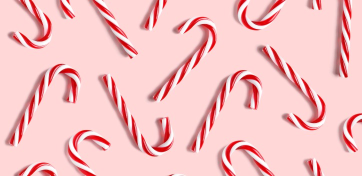 candy canes against a pink background