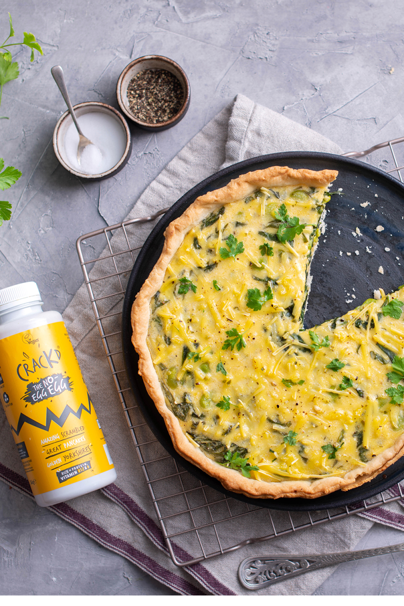 Crackd quiche in a pan next to bottle of Crackd The no-egg egg