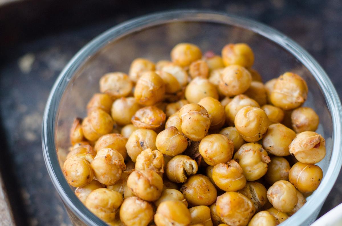 Chickpeas in a clear bowl on a black background