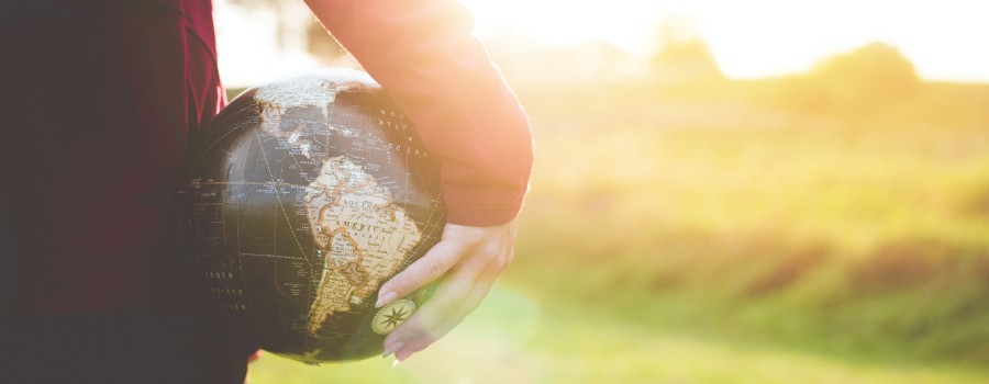 globe being held looking on to a field