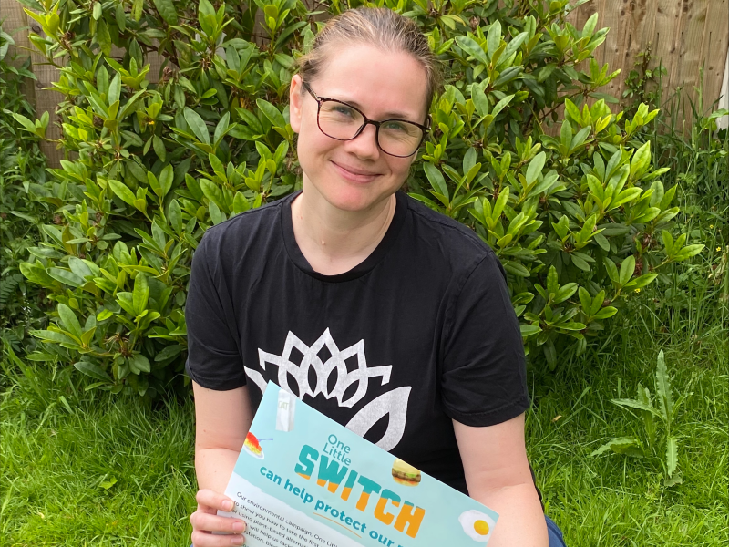 Vegan Society Volunteering Coordinator, Katy Malkin, holding One Little Switch poster