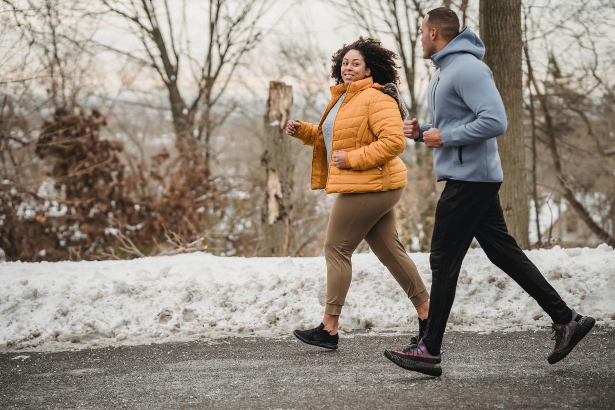 Two people running outside in the cold weather