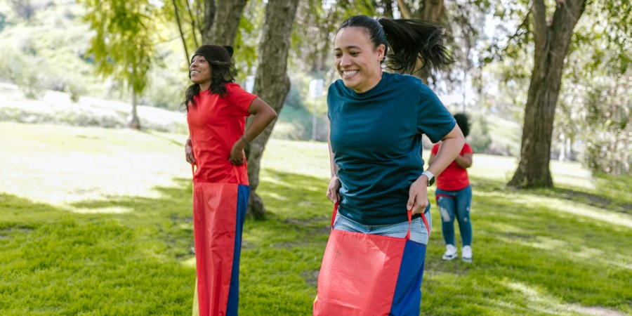 image of people outside taking part in a sack race