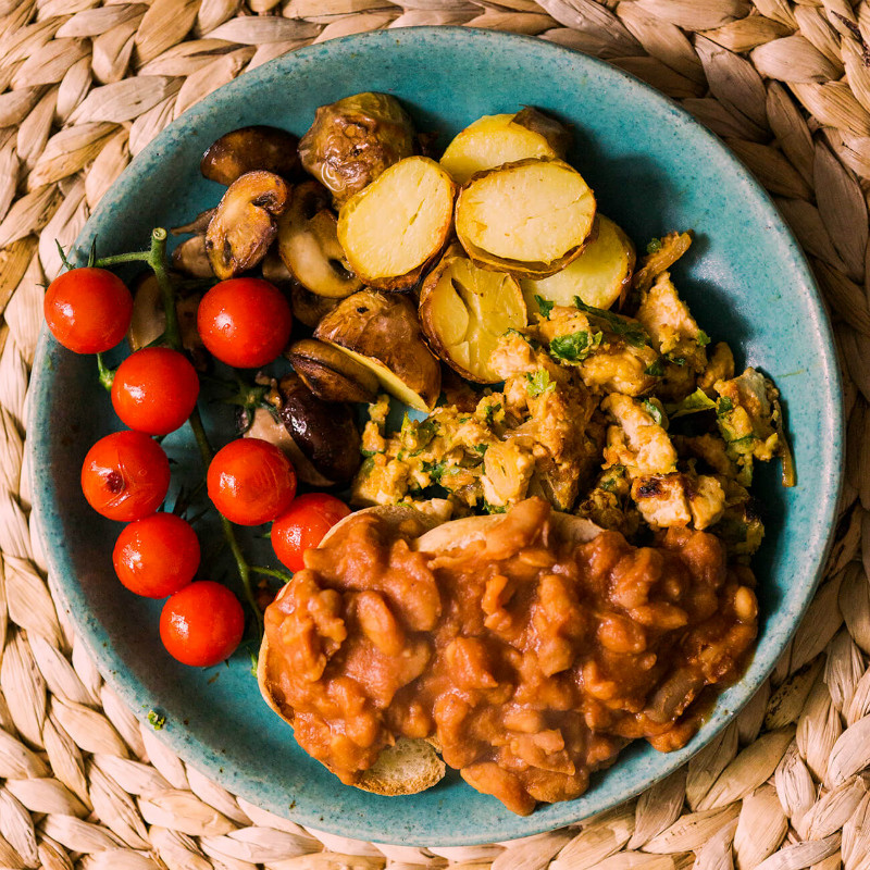 Day Radley's scrambled tofu recipe plate up with potatoes, tomatoes and beans.