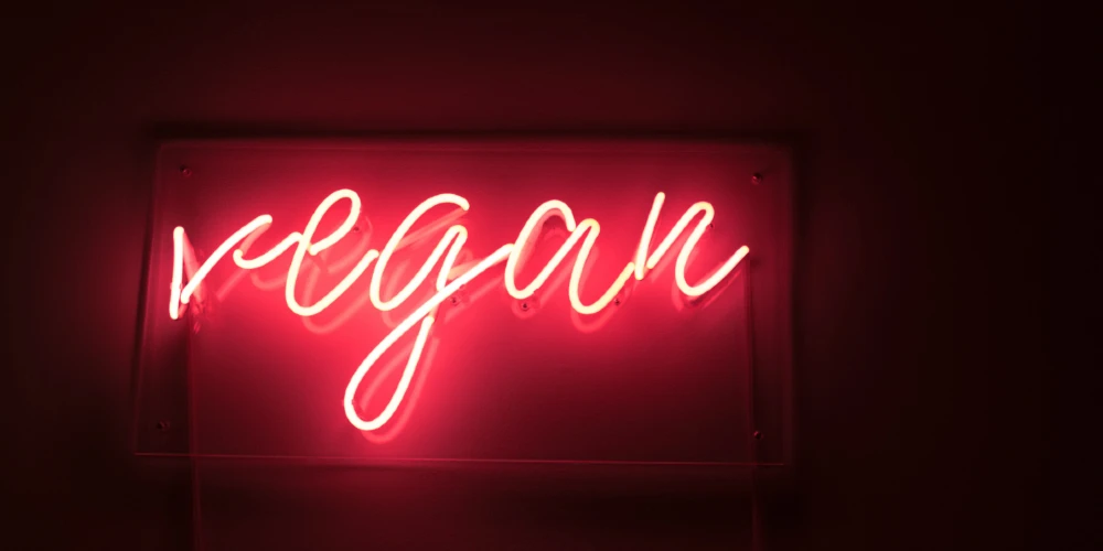 vegan neon red sign lit up in the dark