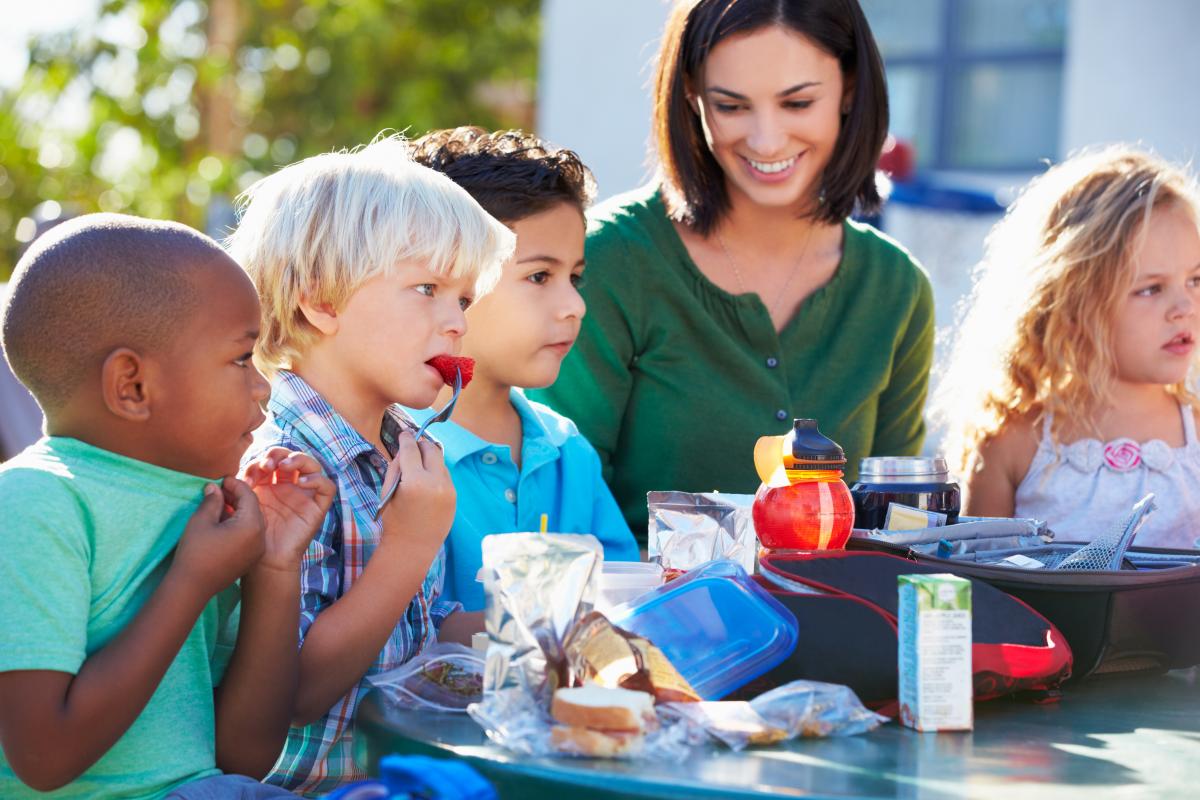 children eating a picnic outside