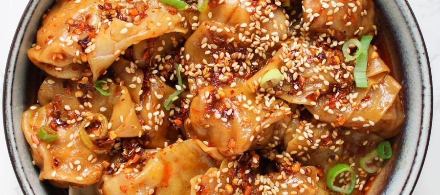 Close up of wontons in chili oil